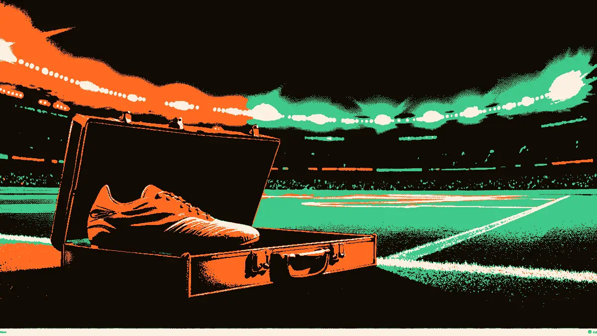 Une paire de crampons posée à côté d'un gant de gardien devant une valise ouverte dans un tunnel de stade, les projecteurs allumés en arrière-plan.