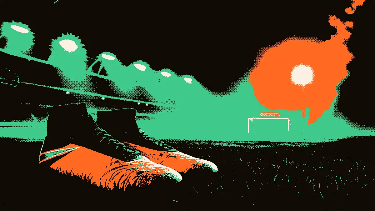 Une paire de crampons posés sur l'herbe près de l'entrée d'un tunnel de vestiaire, avec les projecteurs d'un stade diffusant une lumière douce dans la brume en arrière-plan.